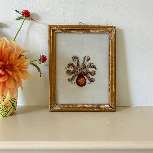 Decorative framed artwork of an octopus on a shelf with flowers. constance-and-denny-indian-reverse-glass-painting-boxed-packaging-hand-painted-artisan-art-octopus