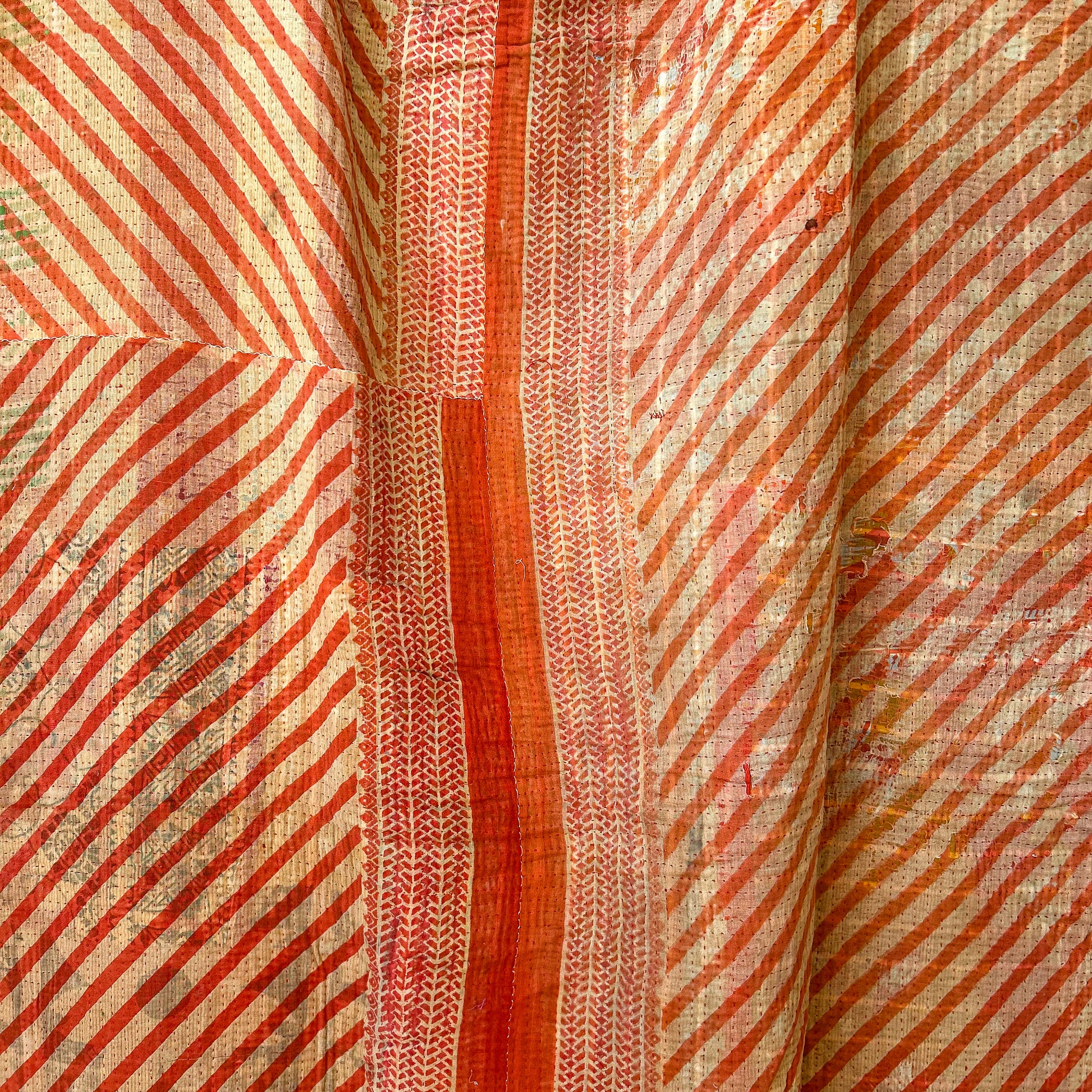 Close-up of fabric with red and beige striped pattern. Vinatge-kantha-2015-rust-A-detail